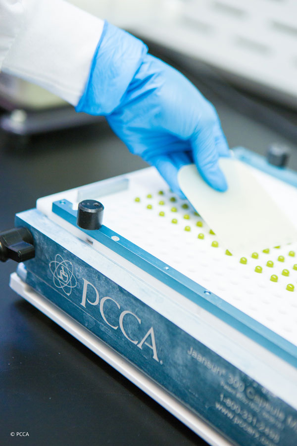 Compounding chemist making capsules